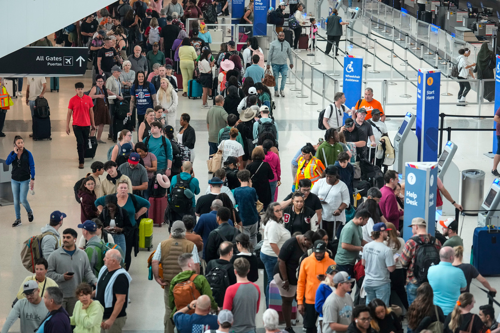 Airline passengers wait in long lines to get through the TSA security screening at William P. Hobby Airport in Houston, Sunday, March 8, 2026. (Brett Coomer/Houston Chronicle via AP)