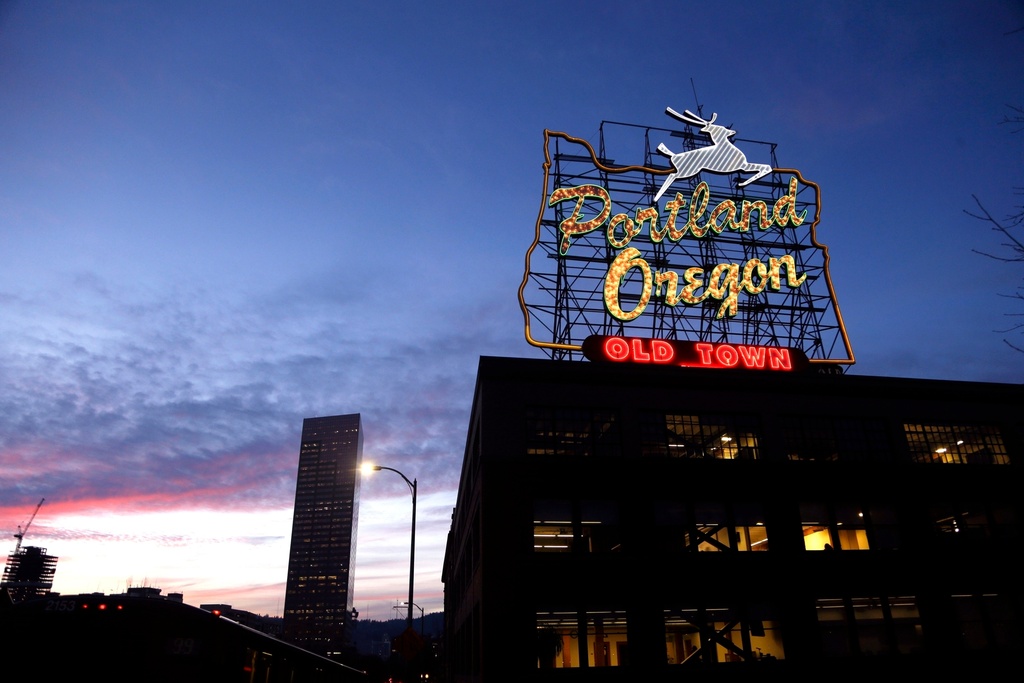 FILE - The "Portland, Oregon" sign is seen atop in building in downtown Portland, Ore., Jan. 27, 2015. (AP Photo/Don Ryan, File)