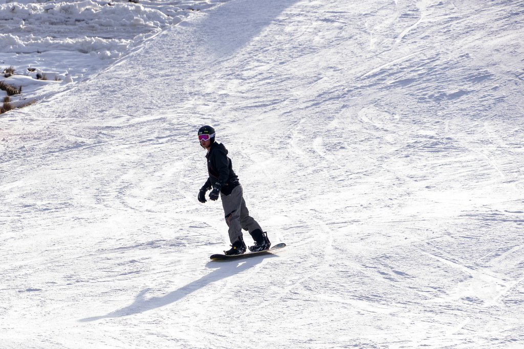 A skier descends carving through the snow at Afriski Mountain Resort in Maluti, Lesotho, Saturday, July 11, 2026. (AP Photo/Kayleen Morgan)