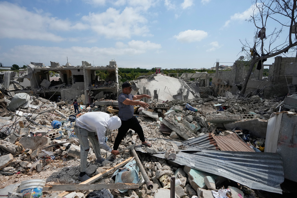 Residents search through the rubble of homes destroyed in an Israeli airstrike a day earlier in the southern village of Charnay, Lebanon, Wednesday, May 27, 2026. (AP Photo/Mohammed Zaatari)