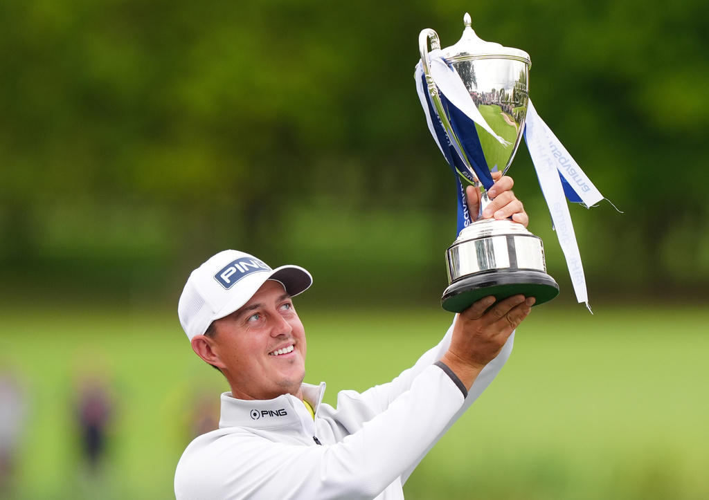 Winner Joe Dean of England celebrates with the trophy on day four of the British Masters at The Belfry Hotel & Resort, Sutton Coldfield, England, Sunday Aug. 30, 2026. (Bradley Collyer/PA via AP)