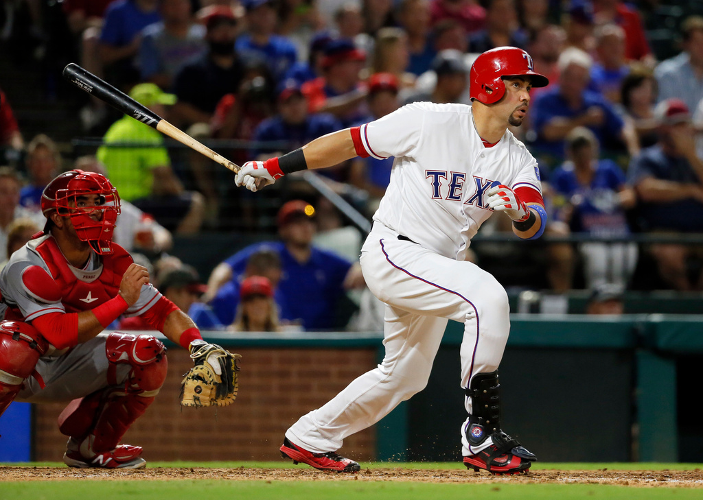 FILE - Texas Rangers' Carlos Beltran follows through on a two-run home run swing as Los Angeles Angels catcher Carlos Perez watches in the fifth inning of a baseball game, Sept. 21, 2016, in Arlington, Texas. (AP Photo/Tony Gutierrez, File)