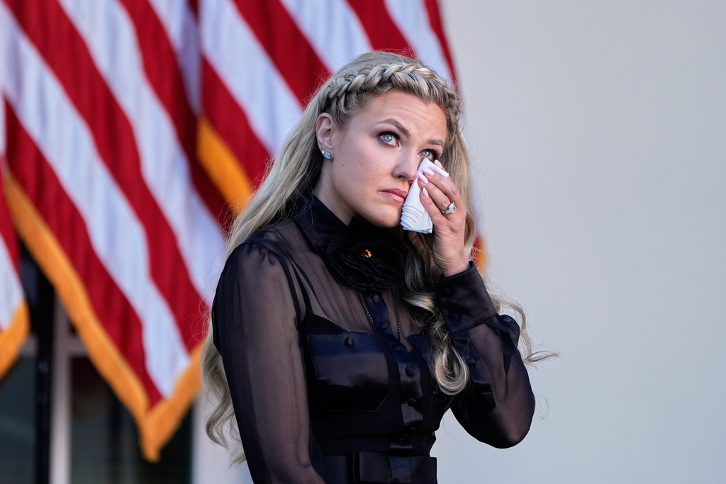 Erika Kirk wipes her eyes as a military aide reads the citation before President Donald Trump posthumously awards the Presidential Medal of Freedom to Charlie Kirk in the Rose Garden of the White House, Tuesday, Oct. 14, 2025, in Washington. (AP Photo/Mark Schiefelbein)