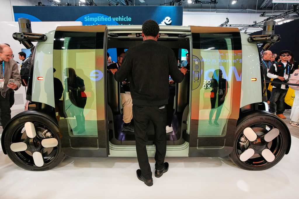 A man looks through the doors of a Zoox vehicle during the CES tech show Tuesday, Jan. 6, 2026, in Las Vegas. (AP Photo/John Locher)