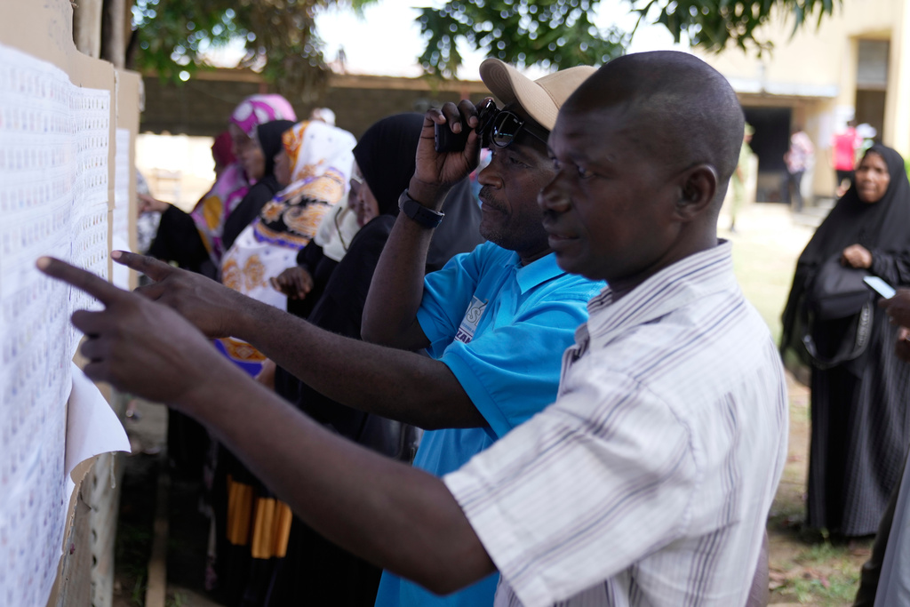Voters verify their names before voting during the general elections at Mpendaye polling station in Zanzibar, Tanzania, Wednesday, Oct. 29, 2025. (AP Photo/Brian Inganga)
