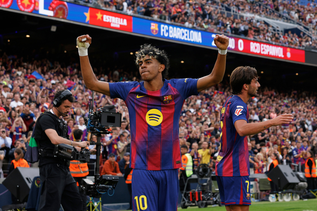 Barcelona's Lamine Yamal celebrates after Ferran Torres, right, scored their side's second goal during the Spanish La Liga soccer match between Barcelona and Espanyol in Barcelona, Spain, Saturday, April 11, 2026. (AP Photo/Joan Monfort)