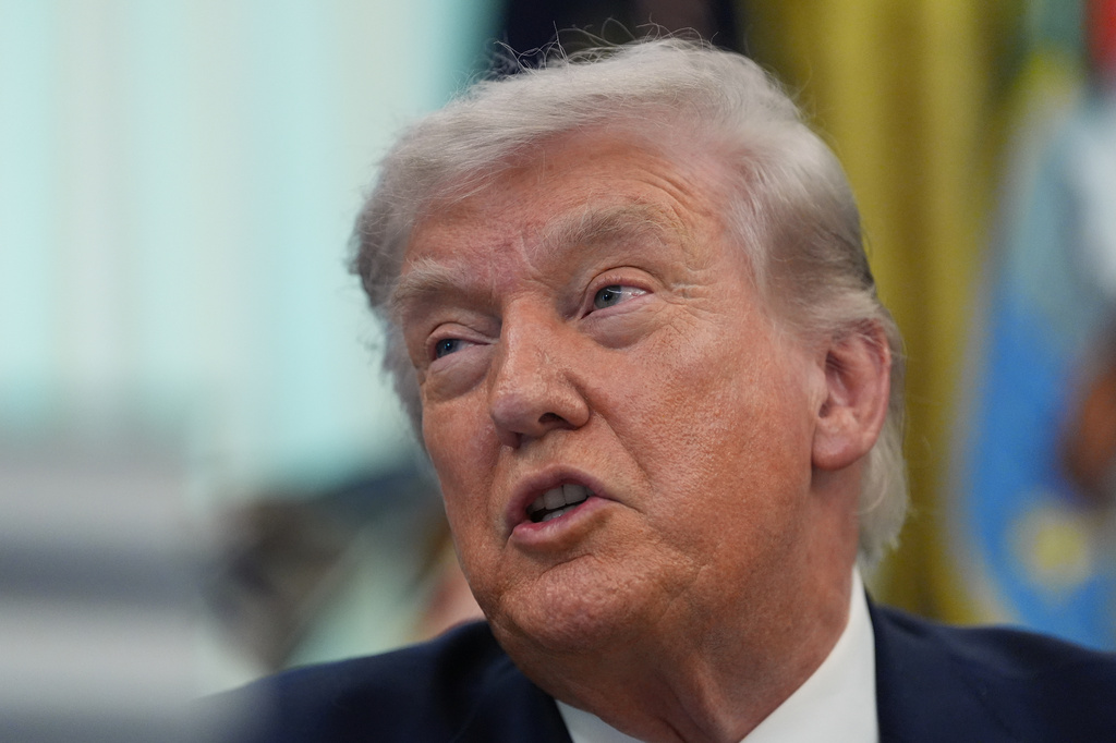 President Donald Trump answers questions from reporters after signing an executive order in the Oval Office of the White House Tuesday, March 31, 2026, in Washington. (AP Photo/Alex Brandon)