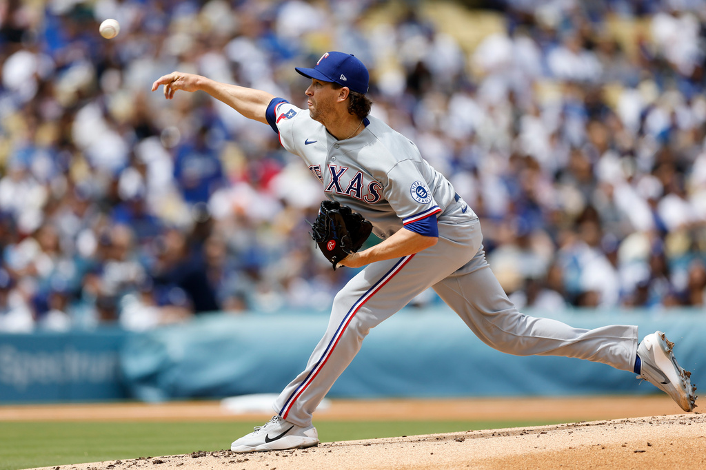 Texas Rangers starting pitcher Jacob deGrom releases a pitch during the first inning of a baseball game against the Los Angeles Dodgers, Sunday, April 12, 2026, in Los Angeles. (AP Photo/Caroline Brehman)