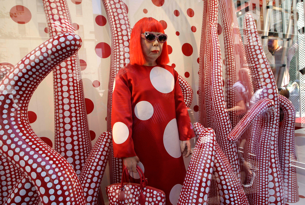 FILE - A wax model of Japanese artist Yayoi Kusama is displayed in the windows of Louis Vuitton's flagship Fifth Avenue store in New York, Tuesday, July 10, 2012. (AP Photo/Kathy Willens, File)