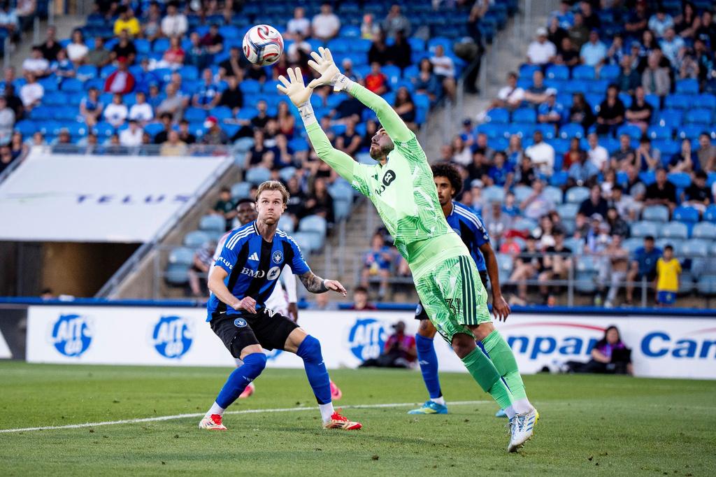 Toronto FC goalkeeper Luka Gavran (1) makes a save during the first half MLS soccer game against CF Montreal, in Montreal on Thursday, July 16, 2026. (Christopher Katsarov/The Canadian Press via AP)