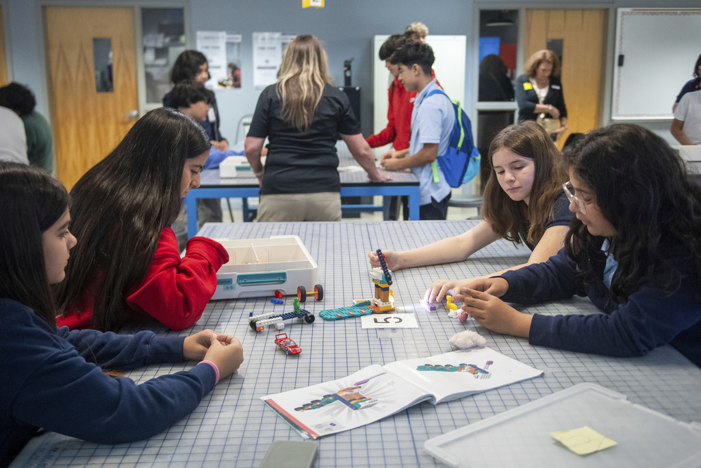 Students work on a project during a LEGO Education science lesson at Lorenzo De Zavala Middle School on Thursday, Aug. 21, 2025, in Irving, Texas. (AP Photo/Ronaldo Bolaños)