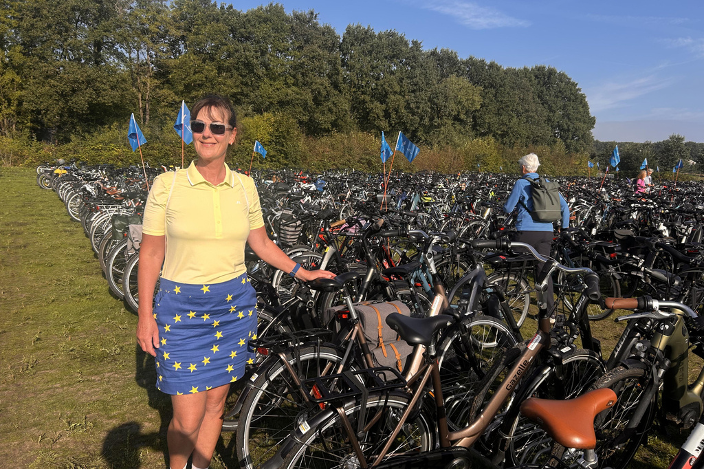In this photo taken with a smartphone, Janet Metcalfe stands with her bike in the bike park at the Solheim Cup venue, Bernardus Golf in in Den Bosch, Netherlands, Saturday Sept. 12, 2026. (AP Photos/Mike Corder)
