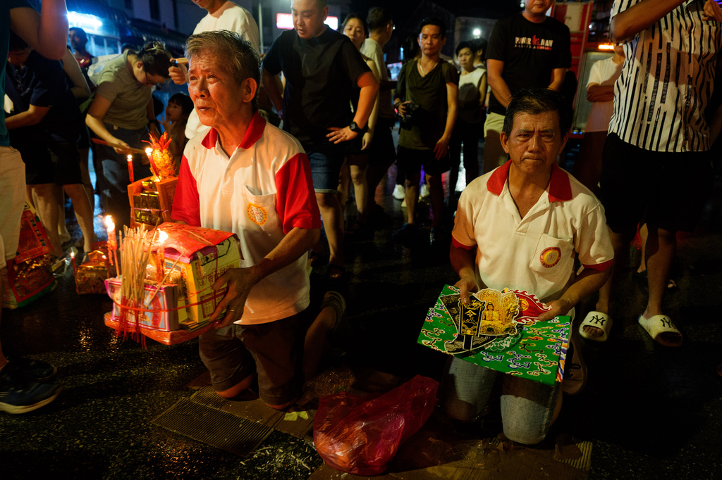 Ethnic Chinese devotees carry paper offerings to be burned during the Hungry Ghost Festival in Bukit Metajam, Malaysia, Saturday, Aug. 29, 2026. (AP Photo/Vincent Thian)