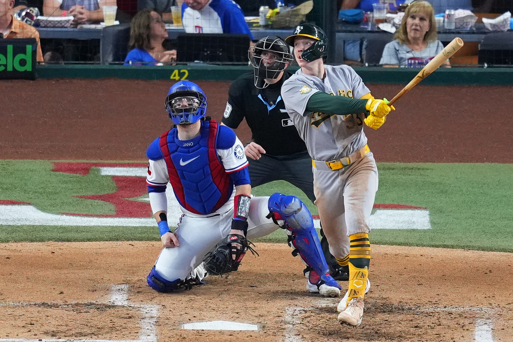 Athletics' Henry Bolte, right, watches his two-run home run as Texas Rangers catcher Danny Jansen, left, and home plate umpire Nic Lentz, center, look on during the fourth inning of a baseball game Wednesday, Sept. 2, 2026, in Arlington, Texas. (AP Photo/Julio Cortez)