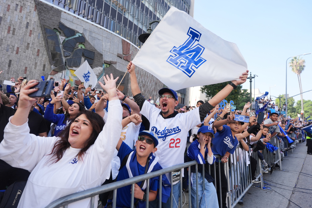 Fans cheer along the route during a parade to celebrate the Los Angeles Dodgers baseball team's World Series win on Monday, Nov. 3, 2025, in Los Angeles. (AP Photo/Jae C. Hong)