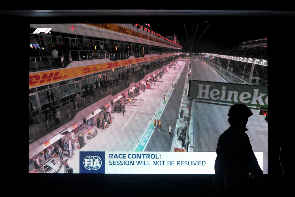 FILE - A fan walks pass a video board after the first practice session for the Formula One Las Vegas Grand Prix auto race was stopped, Thursday, Nov. 16, 2023, in Las Vegas. (AP Photo/Darron Cummings, File)