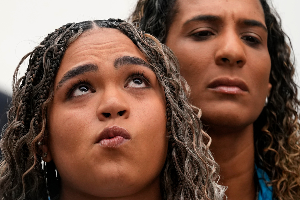 Luyara Franco, daughter of late councilwoman Marielle Franco, and her aunt Anielle Franco give a press conference at the Supreme Court before the start of the first day of trial of those accused of ordering Marielle's murder, in Brasilia, Brazil, Tuesday, Feb. 24, 2026. (AP Photo/Eraldo Peres)