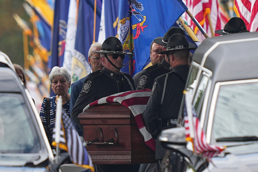 Pall bearers carry the coffin of a slain officer at the conclusion of funeral services for Northern York County Regional Police detectives Cody Michael Becker, Mark Edward Baker and Isaiah Emenheiser, Thursday, Sept. 25, 2025, in Red Lion, Pa. (AP Photo/Matt Rourke)