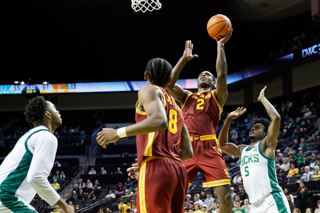 Southern California forward Ezra Ausar (2) shoots against Oregon in the second half of an NCAA college basketball game in Eugene, Ore., Tuesday, Dec. 2, 2025. (AP Photo/Thomas Boyd)