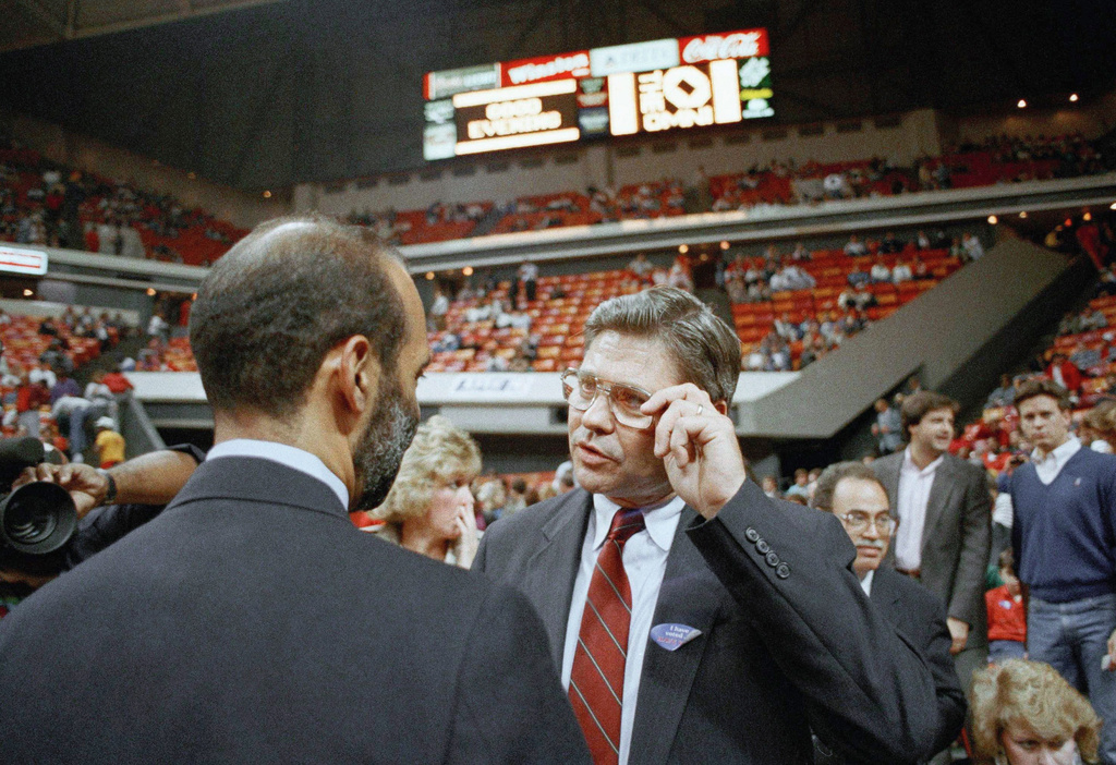 FILE - Congressional candidate Ben Jones, center, prepares to watch the Hawks-Pacers NBA game at the Omni arena Nov. 8, 1988, Atlanta, GA. (AP Photo/Joe Holloway Jr., File)