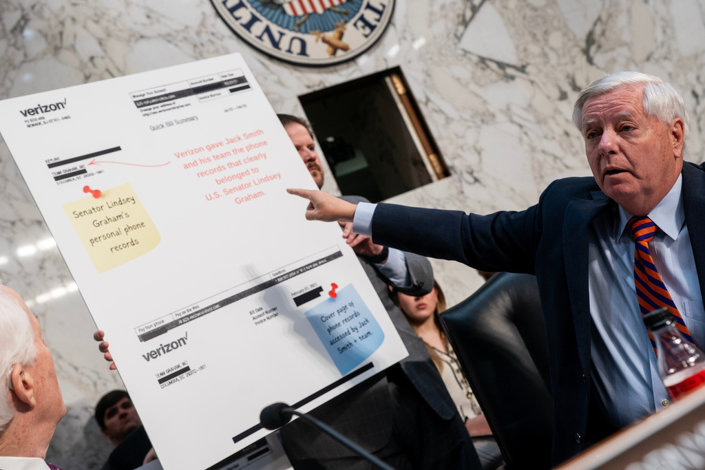 Sen. Lindsey Graham, R-S.C., points to a copy of his Verizon phone bill during a Senate Committee on the Judiciary Subcommittee on Privacy, Technology, and the Law hearing to examine Arctic Frost accountability, focusing on oversight of telecommunications carriers on Capitol Hill in Washington, Tuesday, Feb. 10, 2026. (AP Photo/Nathan Howard)