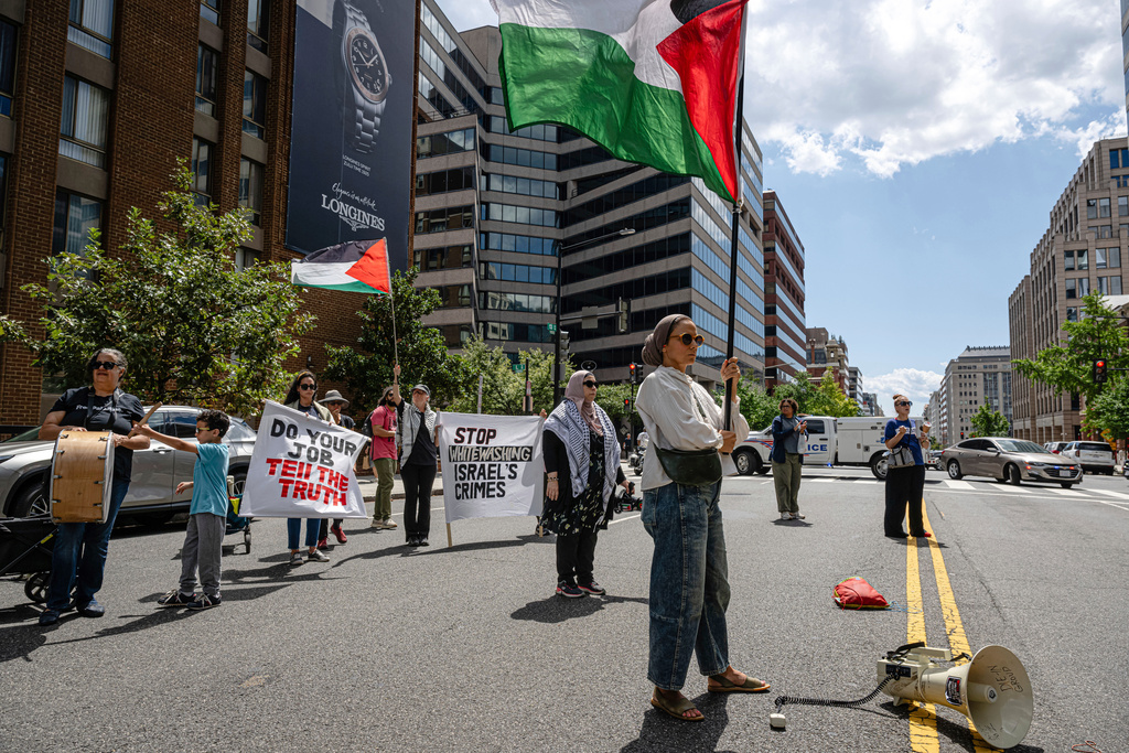 Pro-Palestinian demonstrators gather for a protest in front of the Associated Press offices, Thursday, Aug. 28, 2025, in Washington. (AP Photo/Jon Cherry)
