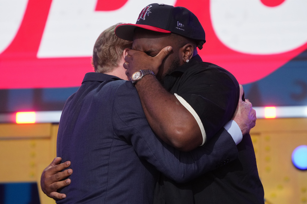 Ohio State defensive lineman Kayden McDonald, right, reacts with NFL Commissioner Roger Goodell after being chosen by the Houston Texans with the 36th overall pick during the second round of the NFL football draft, Friday, April 24, 2026, in Pittsburgh. (AP Photo/Gene J. Puskar)