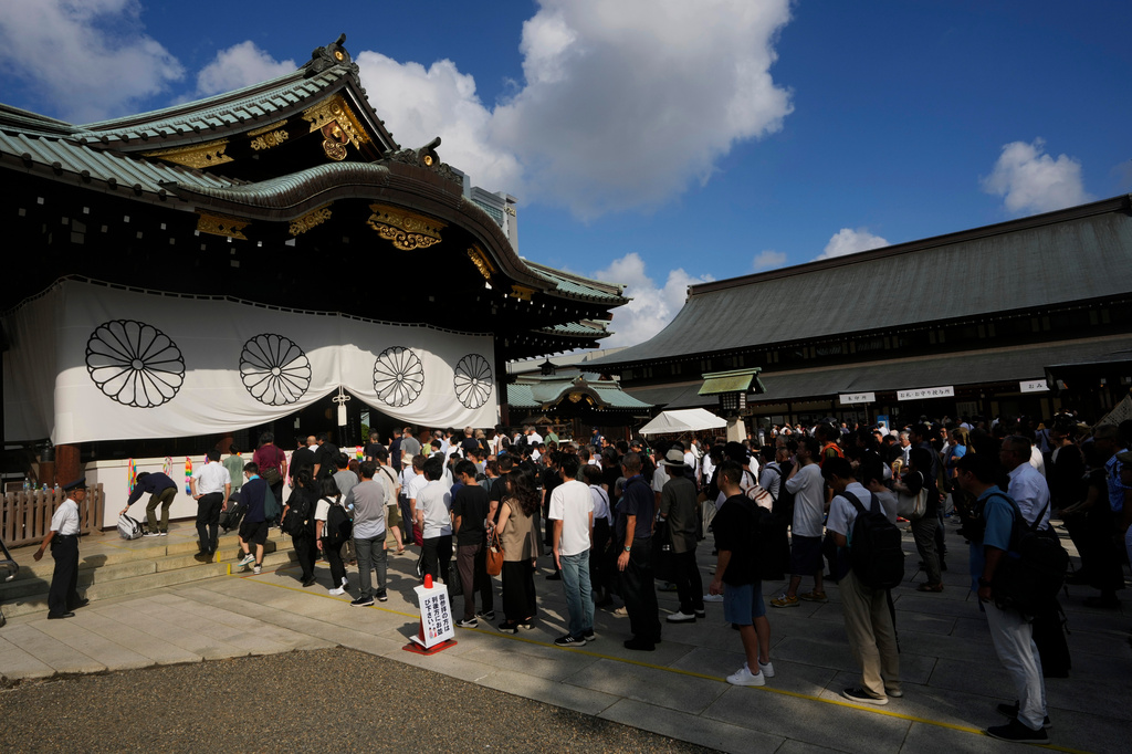 FILE - People wait to pray at the main hall at Yasukuni Shrine, which honors Japan's war dead, in Tokyo on Aug. 15, 2024, as the country marks the 79th anniversary of its defeat in the World War II. (AP Photo/Hiro Komae, File)