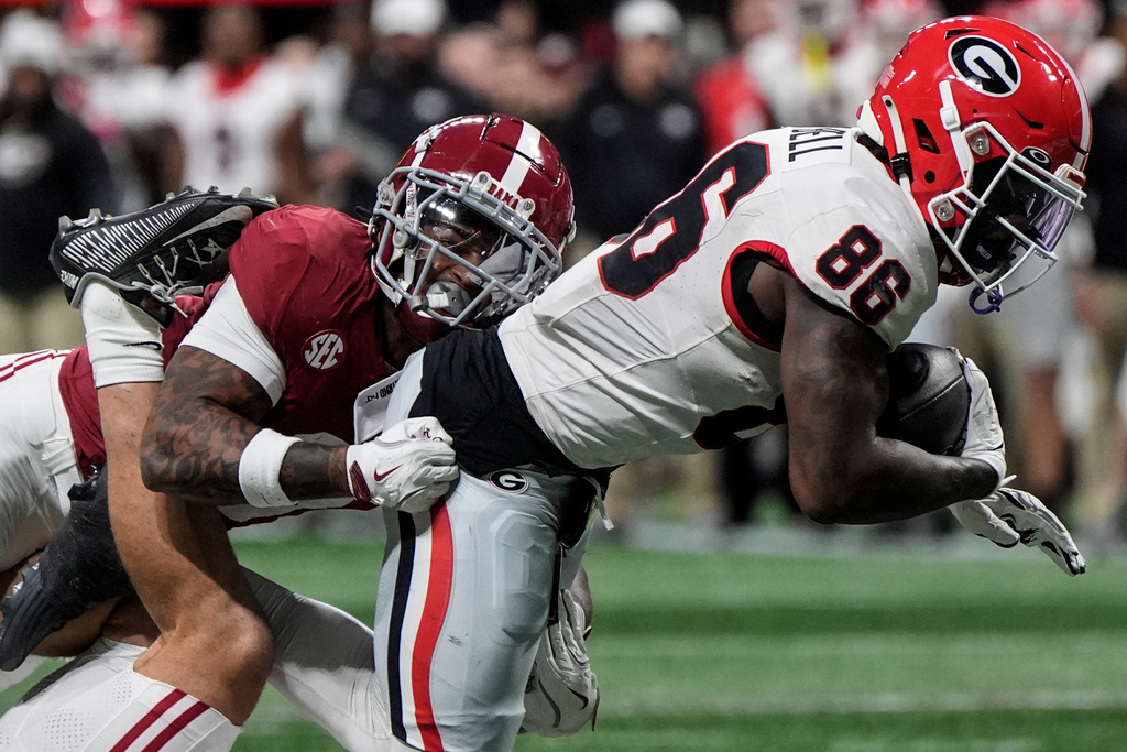 Georgia running back Nate Frazier (3) is hit by Alabama defensive back Keon Sabb (3) during the first half of a Southeastern Conference championship NCAA college football game, Saturday, Dec. 6, 2025, in Atlanta. (AP Photo/Mike Stewart)
