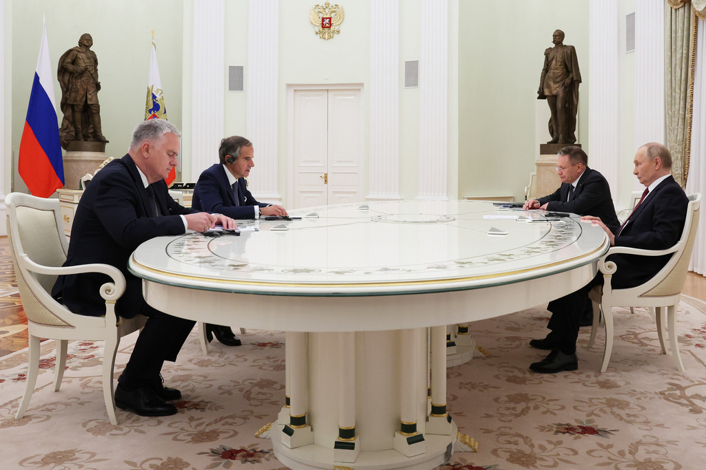 Russian President Vladimir Putin, right, accompanied by Russian State Atomic Energy Corporation Rosatom CEO Alexey Likhachev, second right, speaks with International Atomic Energy Agency (IAEA) Director General Rafael Grossi, second left, during their meeting at the Senate Palace of the Kremlin in Moscow, Russia, Thursday, Sept. 25, 2025. (Ramil Sitdikov/Pool Photo via AP)