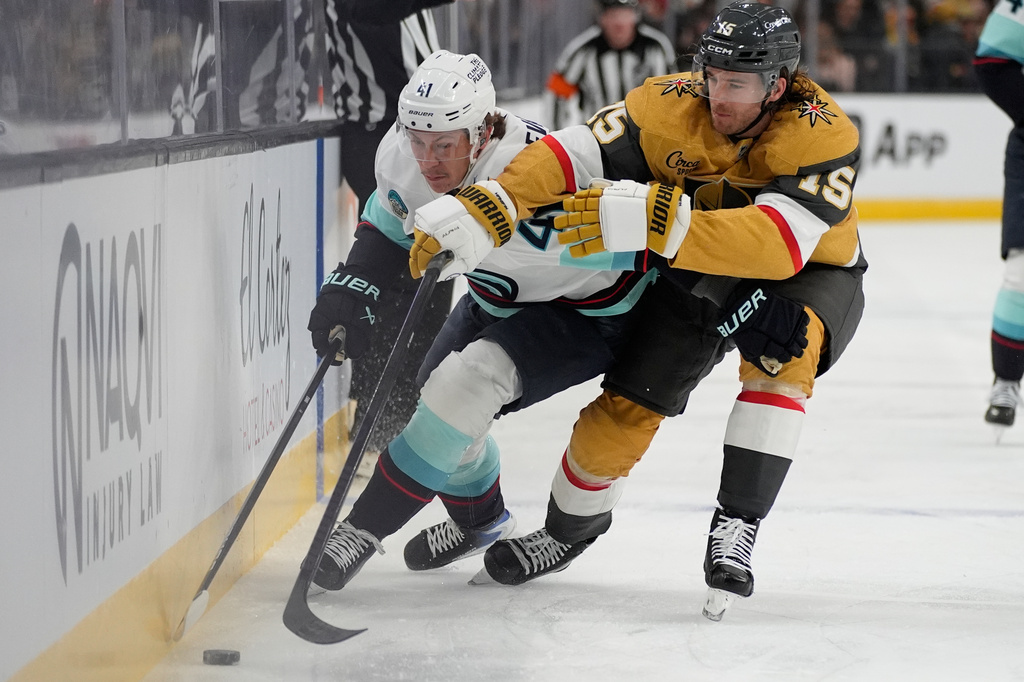 Seattle Kraken defenseman Ryker Evans (41) skates against Vegas Golden Knights defenseman Noah Hanifin (15) during the first period of an NHL hockey game Wednesday, April 15, 2026, in Las Vegas. (AP Photo/John Locher)