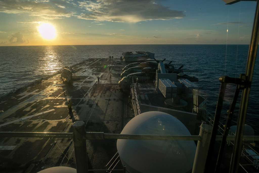 This image from video provided by U.S. Central Command shows U.S. Sailors and Marines aboard USS Tripoli arriving in the U.S. Central Command area of responsibility, March 27, 2026. (U.S. Central Command via AP)