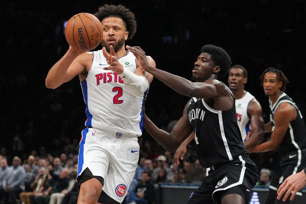 Detroit Pistons' Cade Cunningham (2) passes away from Brooklyn Nets' Drake Powell (4) during the first half of an NBA basketball game Tuesday, March 10, 2026, in New York. (AP Photo/Frank Franklin II)