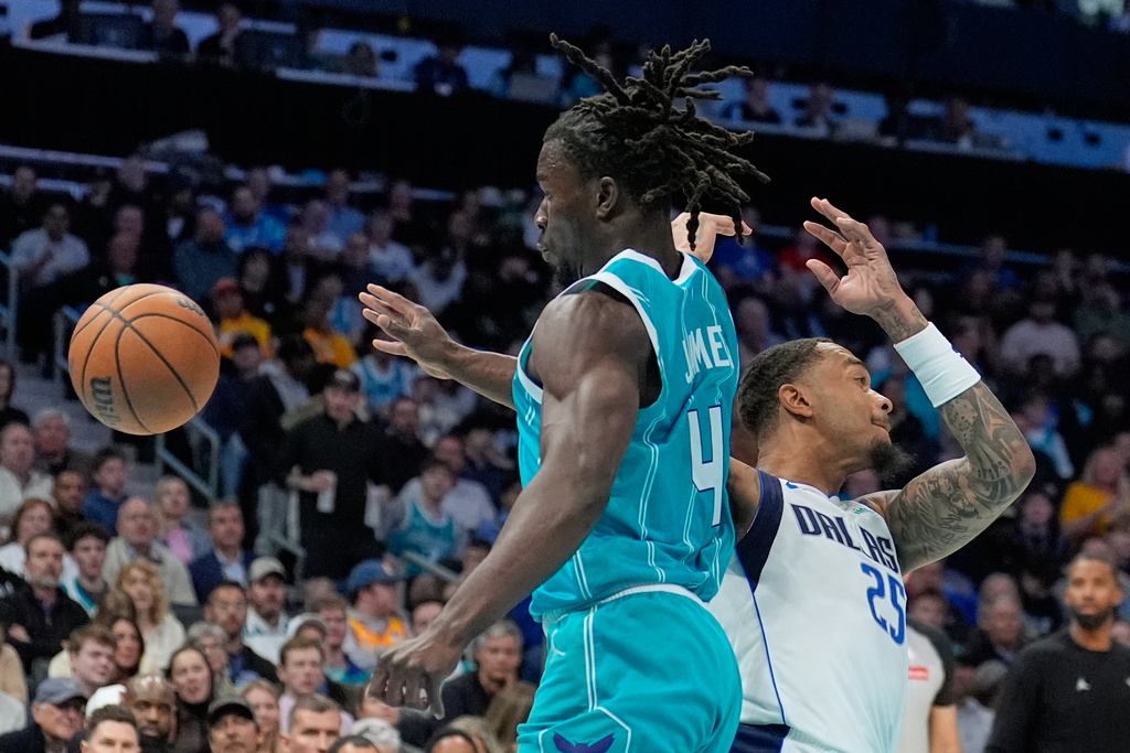 Charlotte Hornets guard Sion James vies for the ball with Dallas Mavericks forward P.J. Washington during the first half of an NBA basketball game, Tuesday, March 3, 2026, in Charlotte, N.C. (AP Photo/Chris Carlson)