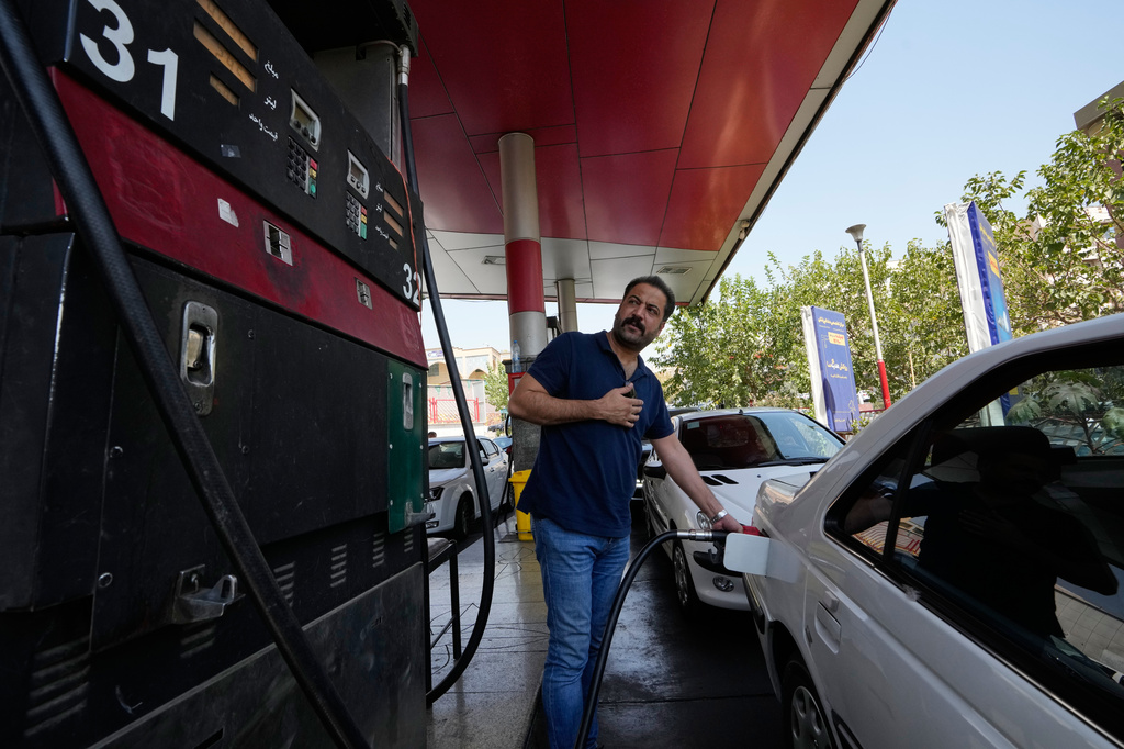 A man is filling up his car at a gas station in Tehran, Iran, Tuesday, Aug. 25, 2026. (AP Photo/Vahid Salemi)