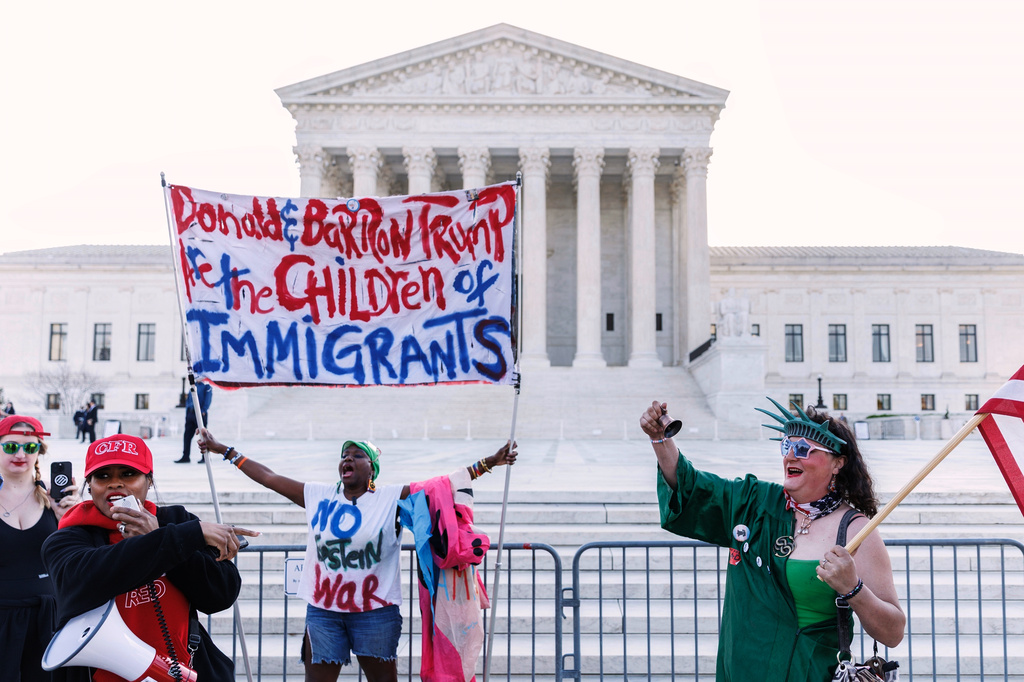 Demonstrators holding opposing views verbally engage ahead of President Donald Trump's arrival at the U.S. Supreme Court, Wednesday, April 1, 2026, in Washington. (AP Photo/Tom Brenner)