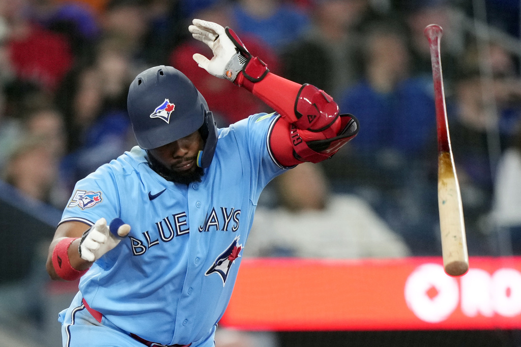 Toronto Blue Jays Vladimir Guerrero Jr. (27) reacts after hitting a pop fly for an out during the fifth inning of a baseball game against the Colorado Rockies in Toronto, Wednesday, April 1, 2026. (Nathan Denette/The Canadian Press via AP)