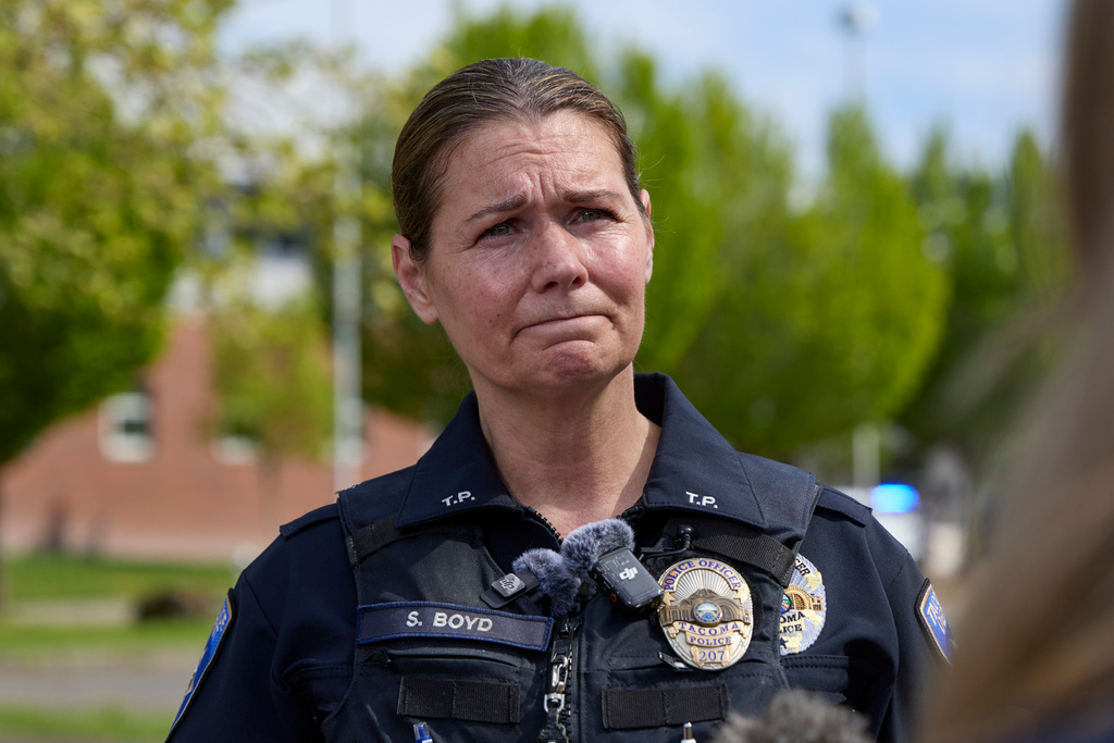 Tacoma Police officer Shelbie Boyd addresses media after multiple people were injured in a stabbing at Foss High School, Thursday, April 30, 2026, in Tacoma, Wash. (AP Photo/John Froschauer)