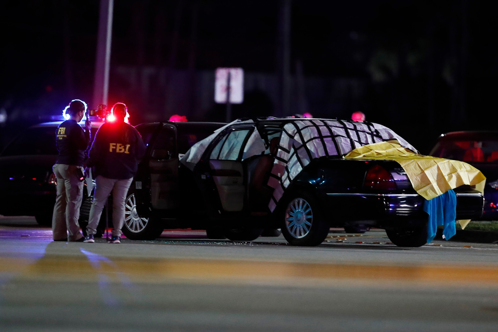 FILE - Authorities investigate the scene of a fatal shooting Dec. 5, 2019, in Miramar, Fla. (AP Photo/Brynn Anderson, File)