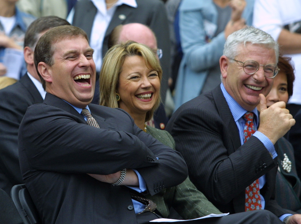 FILE - Prince Andrew, the Duke of York, left, laughs before the start of a concert in New York's Washington Square Park, Oct. 14, 2001. (AP Photo/Diane Bondareff, File)