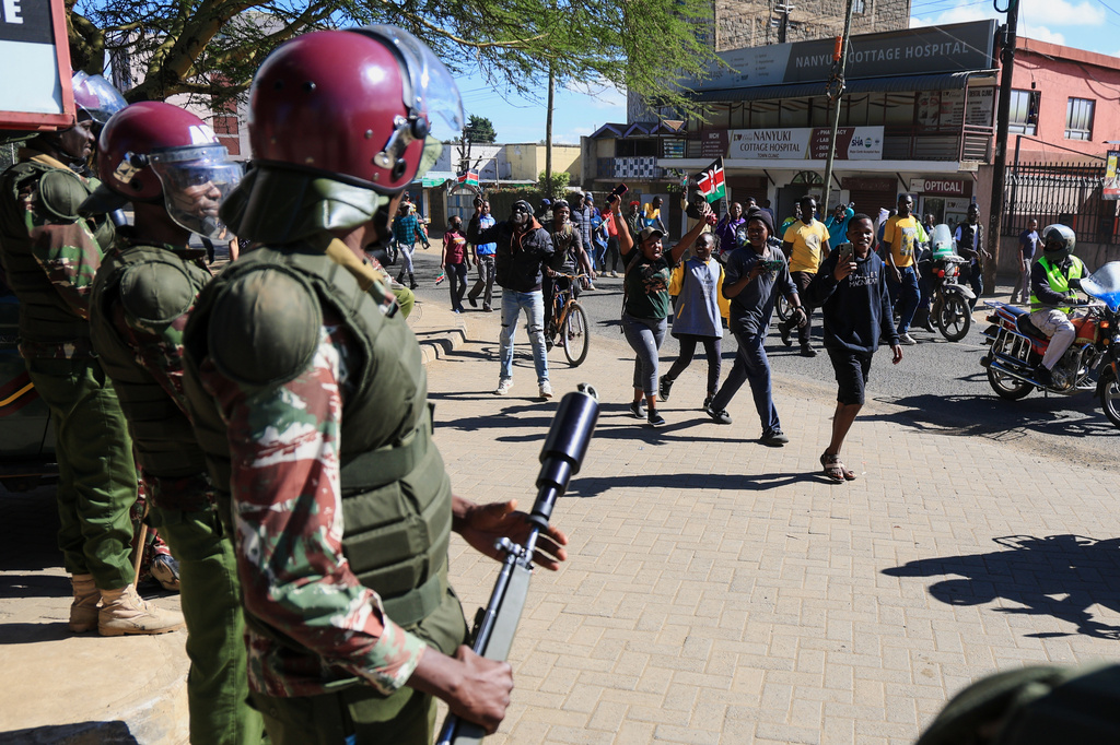 Anti-riot police officers stand by as demonstrators protest against a proposed Ebola quarantine center to be established by the United States at Laikipia Air Base in Nanyuki, Kenya, Monday, June 1, 2026. (AP Photo/Andrew Kasuku)