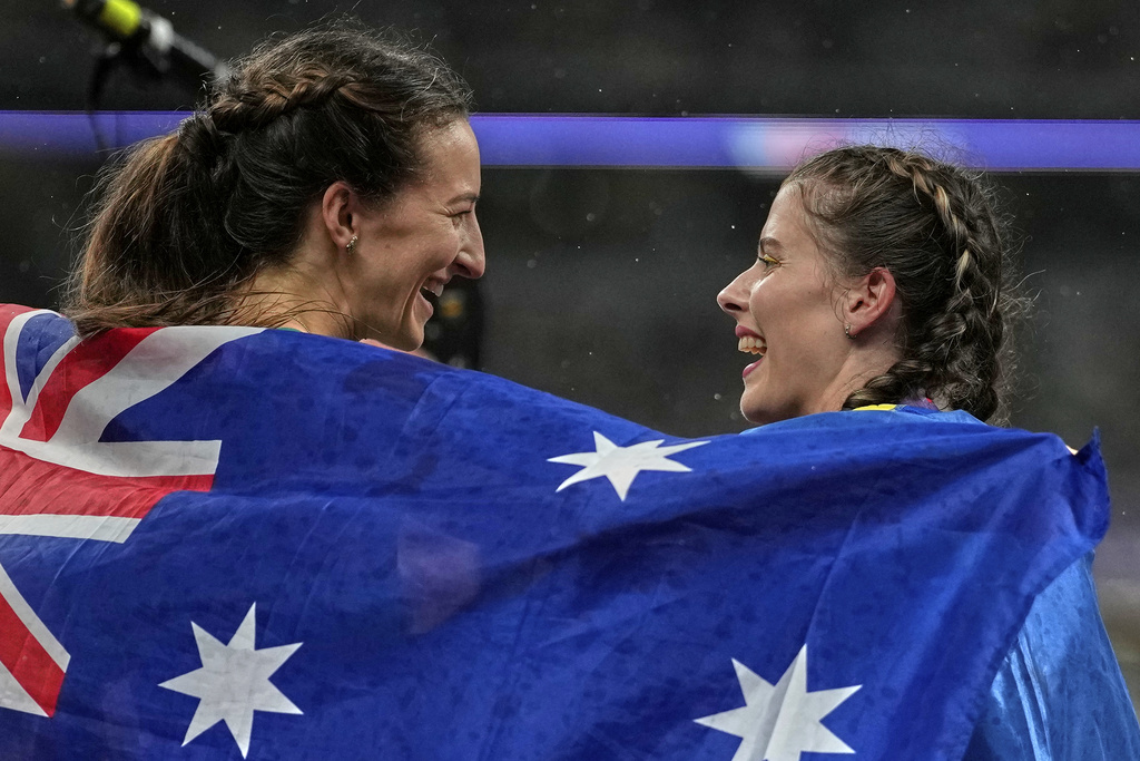 Australia's Nicola Olyslagers, gold, celebrates with Ukraine's Yaroslava Mahuchikhn after the women's high jump final at the World Athletics Championships in Tokyo, Sunday, Sept. 21, 2025. (AP Photo/Louise Delmotte)