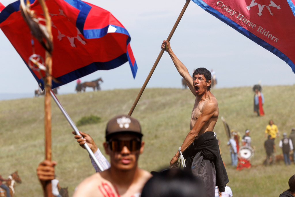 Riders celebrate the horse charge event during festivities to commemorate the 150th anniversary of the Battle of the Little Bighorn in Crow Agency, Mont., on Thursday, June 25, 2026. (AP Photo/Tailyr Irvine)