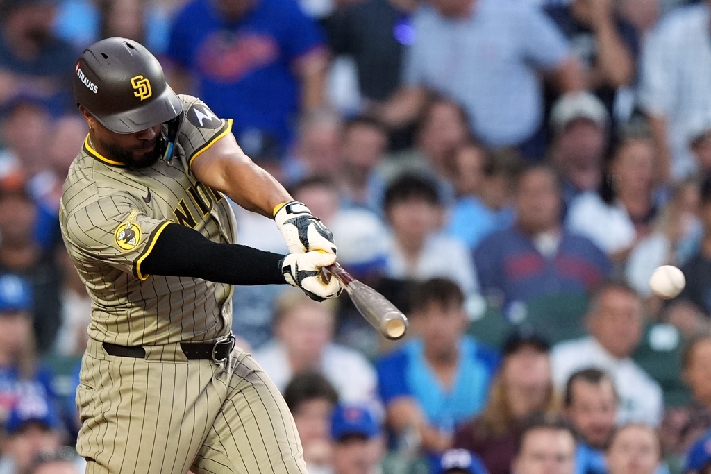 San Diego Padres' Xander Bogaerts hits a single during the seventh inning of Game 3 of a National League wild card baseball game against the Chicago Cubs Thursday, Oct. 2, 2025, in Chicago. (AP Photo/Nam Huh)