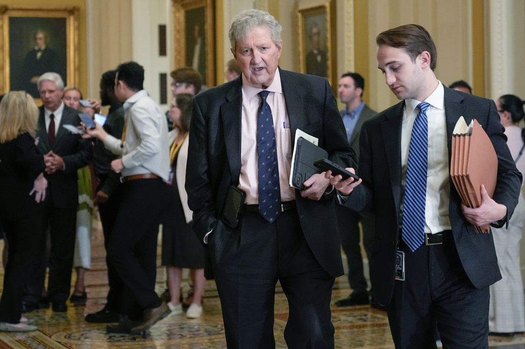 Sen. John Kennedy, R-La., center, speaks with a reporter, Tuesday, April 14, 2026, in Washington. (AP Photo/Mariam Zuhaib)