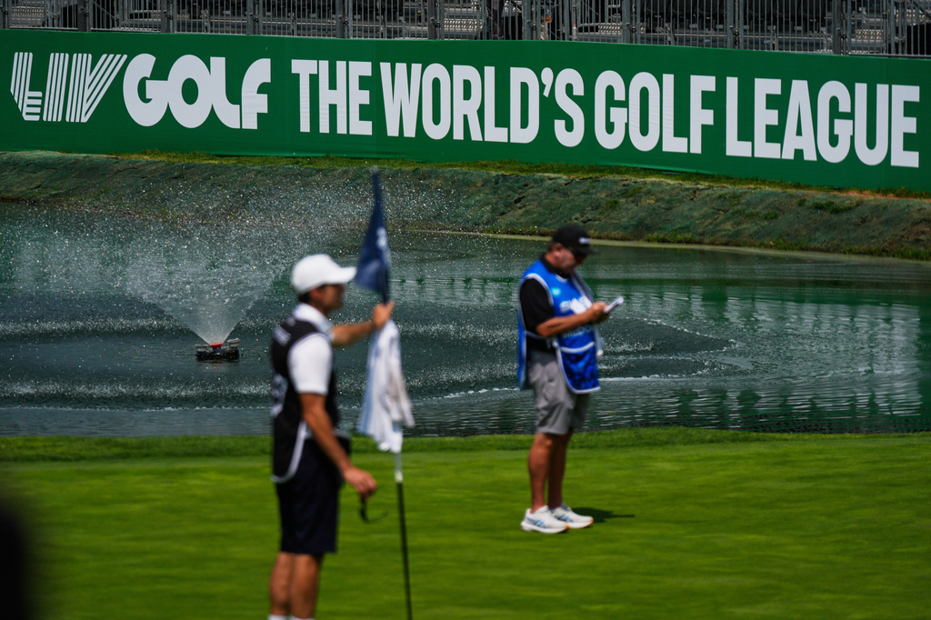 A caddie studies the putting green at the 18th hole during the first round of the LIV Golf tournament in Naucalpan on the outskirts of Mexico City, Thursday, April 16, 2026. (AP Photo/Fernando Llano)
