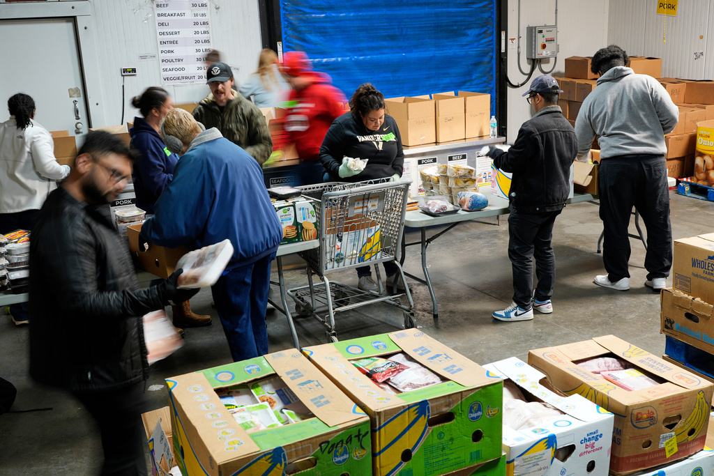 Volunteers fill food boxes for clients at Second Harvest Food Bank, Tuesday, Nov. 4, 2025, in Nashville, Tenn. (AP Photo/George Walker IV)