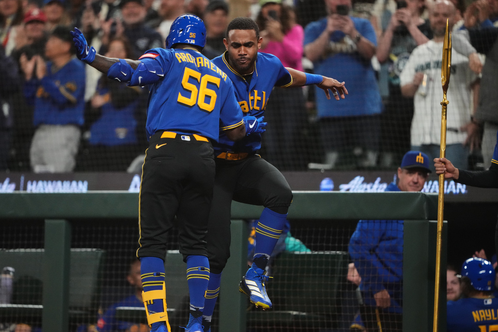 Seattle Mariners' Randy Arozarena (56) celebrates his two-run home run with Julio Rodríguez, facing against the Houston Astros during the fifth inning of a baseball game, Friday, April 10, 2026, in Seattle. (AP Photo/Lindsey Wasson)