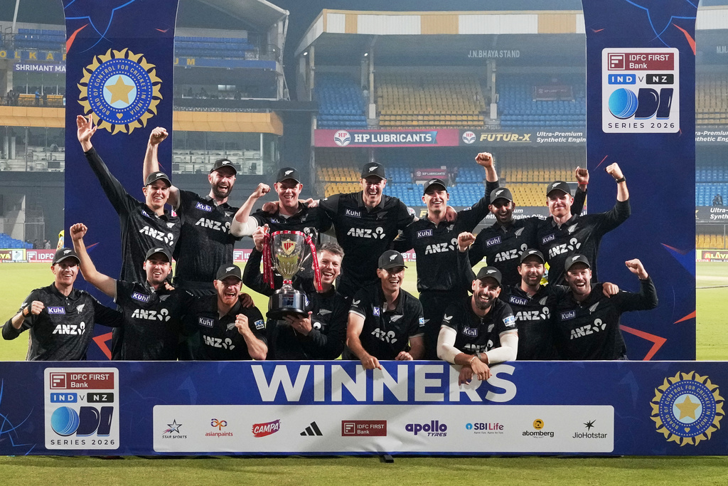 New Zealand's players pose with the trophy after winning the One Day International cricket series against India in Indore, India, Sunday, Jan. 18, 2026. (AP Photo/Rafiq Maqbool)