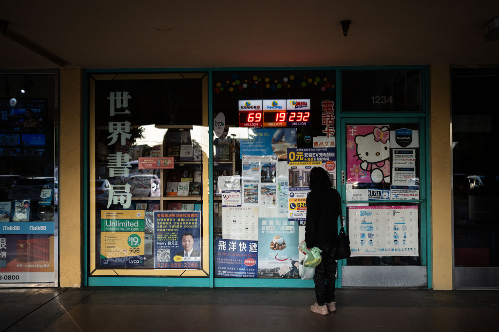 A person stands outside a Chinese-language bookstore in Arcadia, Calif., Tuesday, May 12, 2026, in the city whose former mayor, Eileen Wang, pleaded guilty to being an illegal agent of the Chinese government. (AP Photo/Jae C. Hong)